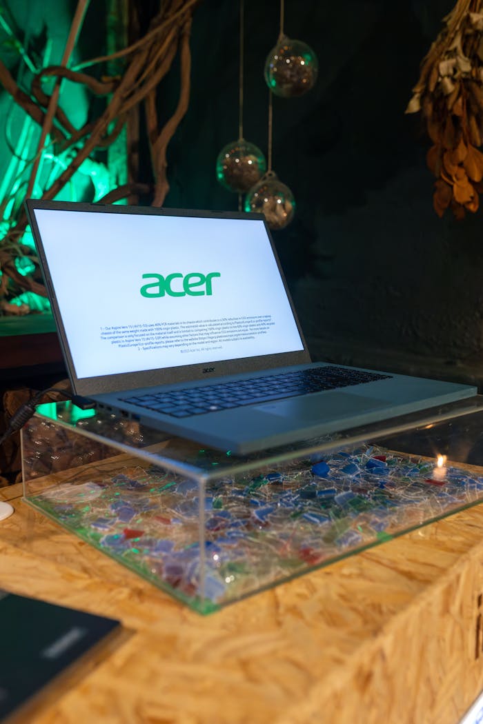 A laptop on a table with a glass top